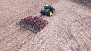 Single pass fall Vertical Tillage to incorporate broadcast rye and size and secure corn residue to the soil