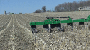 A Crop Row Cleaner with a two-stacked row cleaner unit pushes corn stalk residue against previous crop stalks to provide cleared space for planting twin row soybeans.